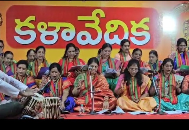 Students and teacher performing at a Kalavedika stage event